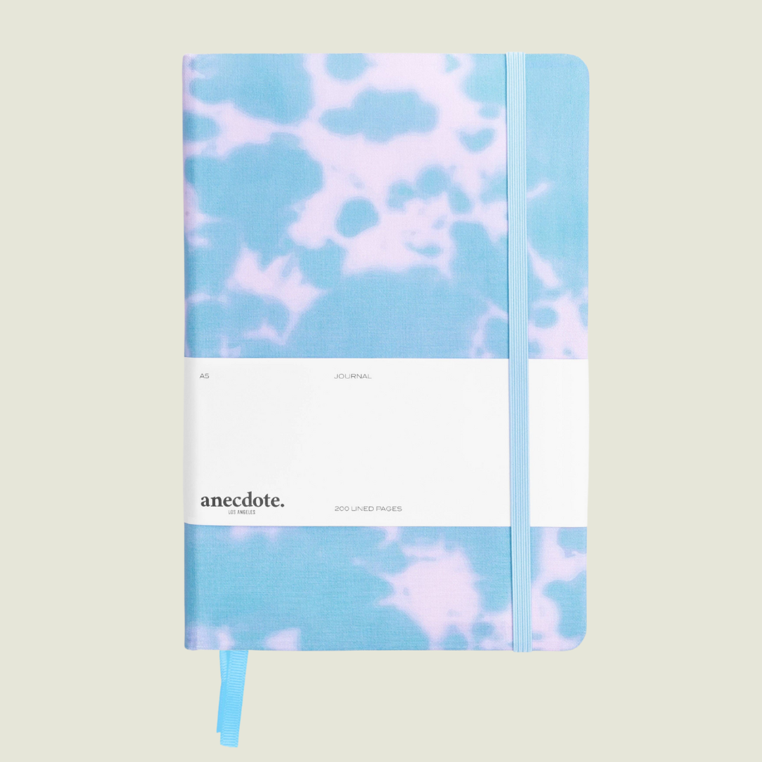 Notebook with tie-dye design on a light beige background.