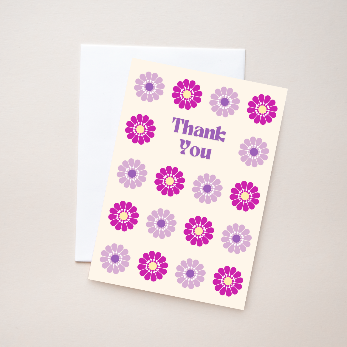 Retro purple flower greeting card with text 'Thank You' on a beige background. 