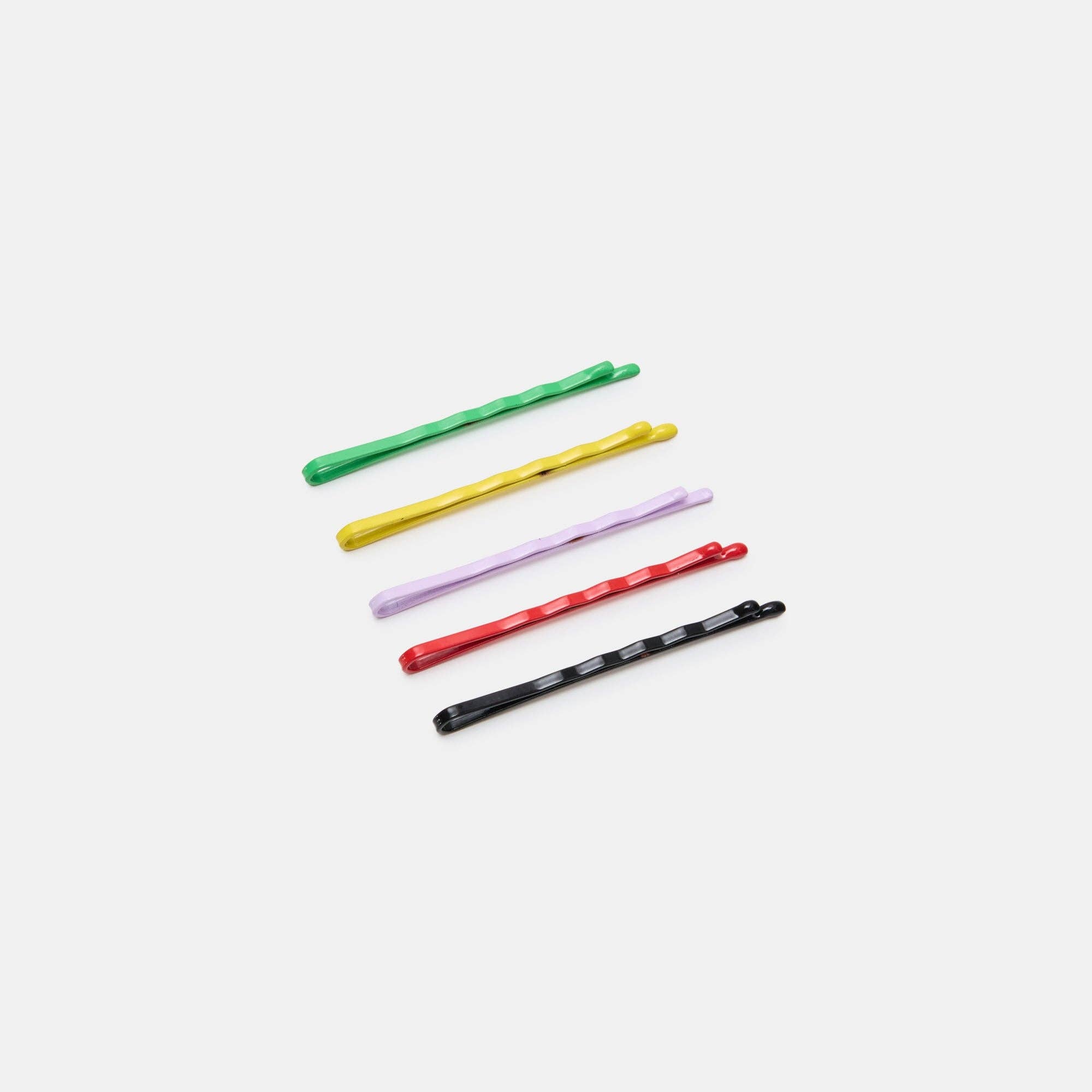 Five colorful hair pins on a white background