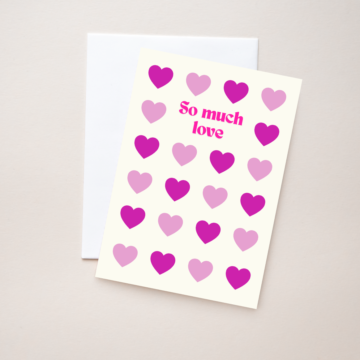 Greeting card with text "So much love" and shades of pink hearts with an envelope on a beige background.